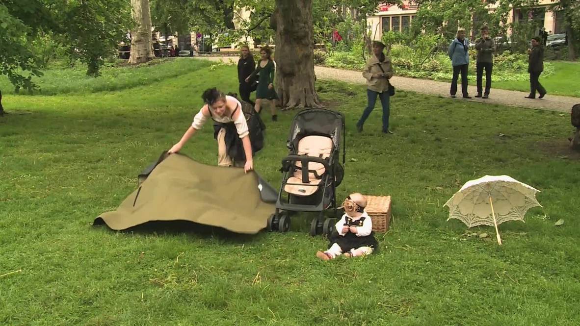 Germany: Fancy-dressed picnickers unperturbed by rainy day