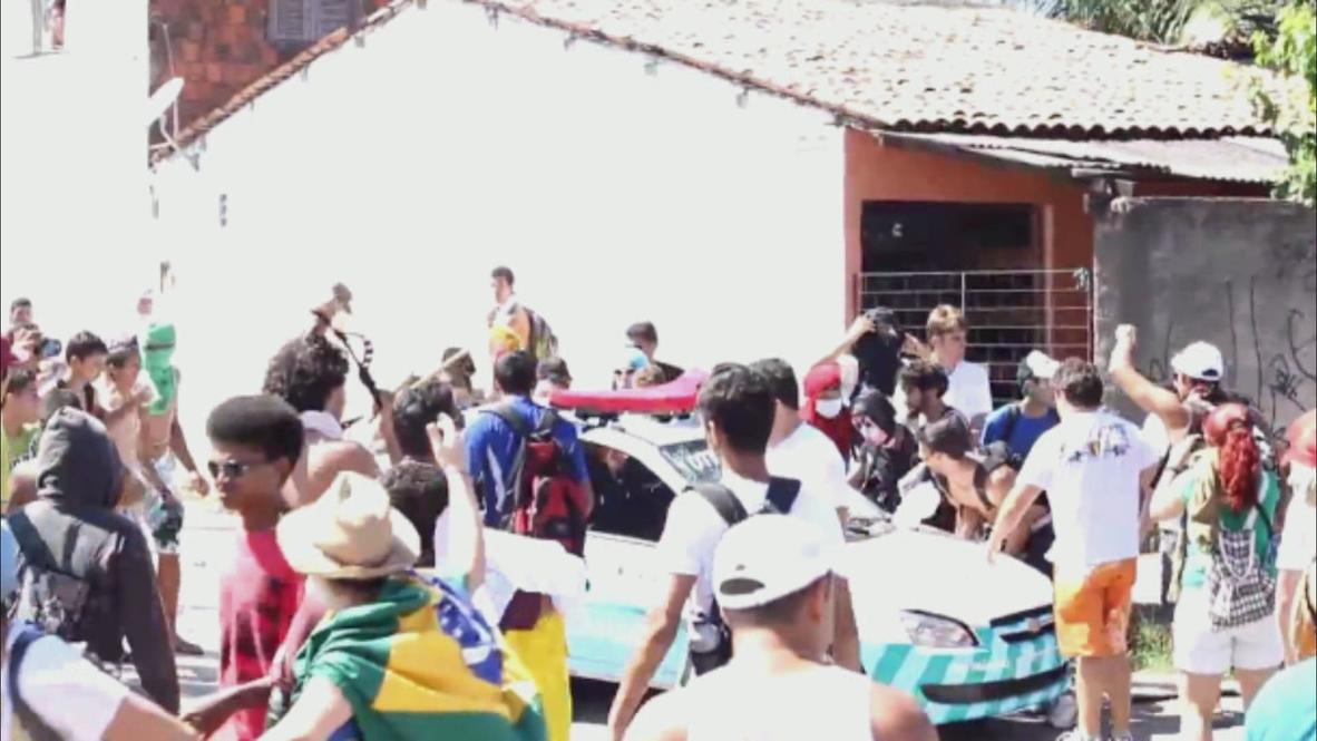 Brazil: Protesters destroy police car despite chants for no violence