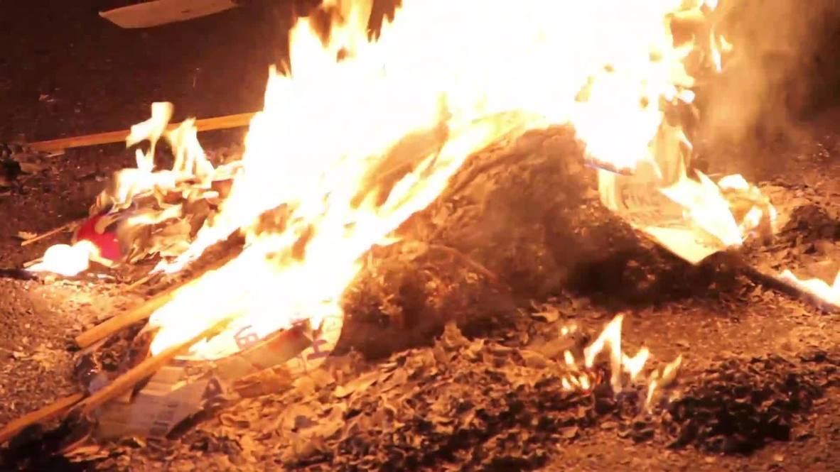 UK: Austerity bonfire sees protesters burn energy bills at houses of parliament