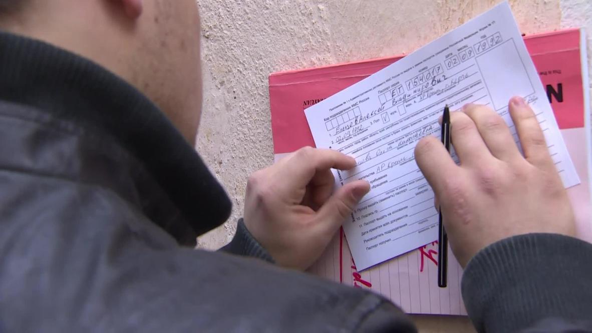 Russia: Crimeans swap Ukrainian passports for Russian