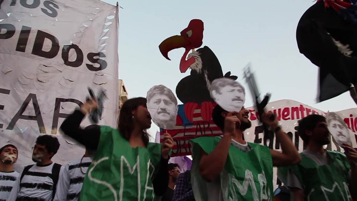 Argentina: See fake AK-47s, mock executions at this anti-debt default demo