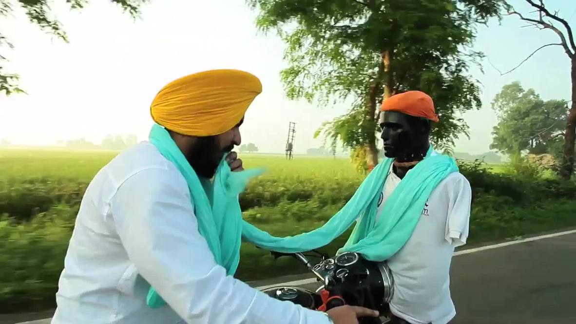 India: Turban-meister! See man wrap turban on moving motorcycle