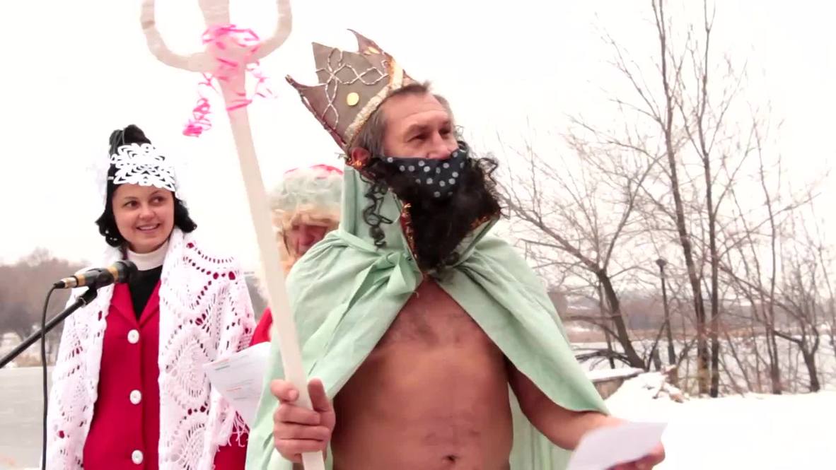 Ukraine: BRRR! See daring Donetskers plunge into ICE WATER for seasonal swim