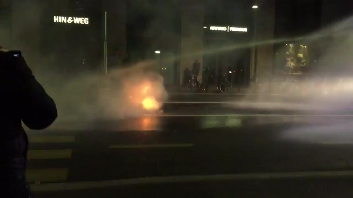 Switzerland: Police battle flames with water cannon