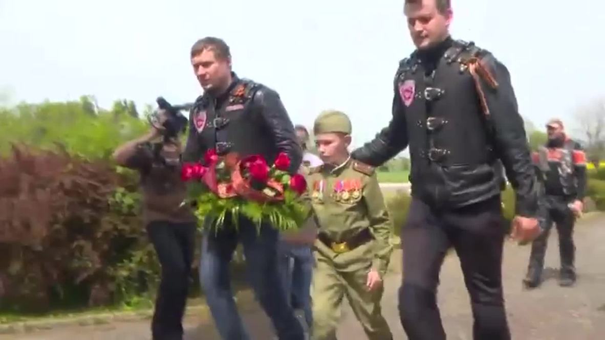 Czech Republic: Night Wolves lay flowers at Soviet War Memorial in Vitejovice