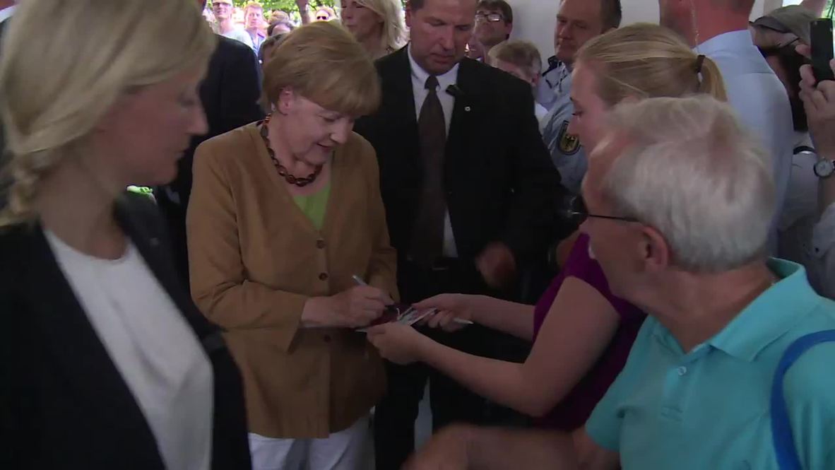 Germany: Merkel signs autographs at German Chancellery open day