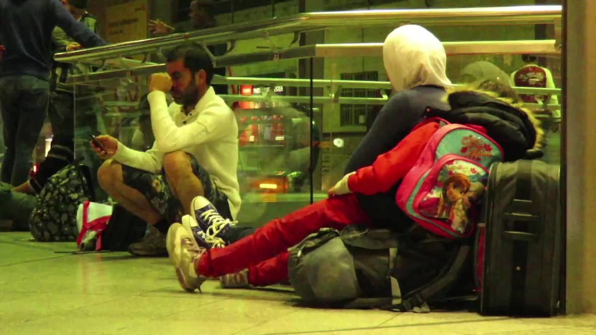 Germany: Exhausted refugees wait for northbound trains in Munich