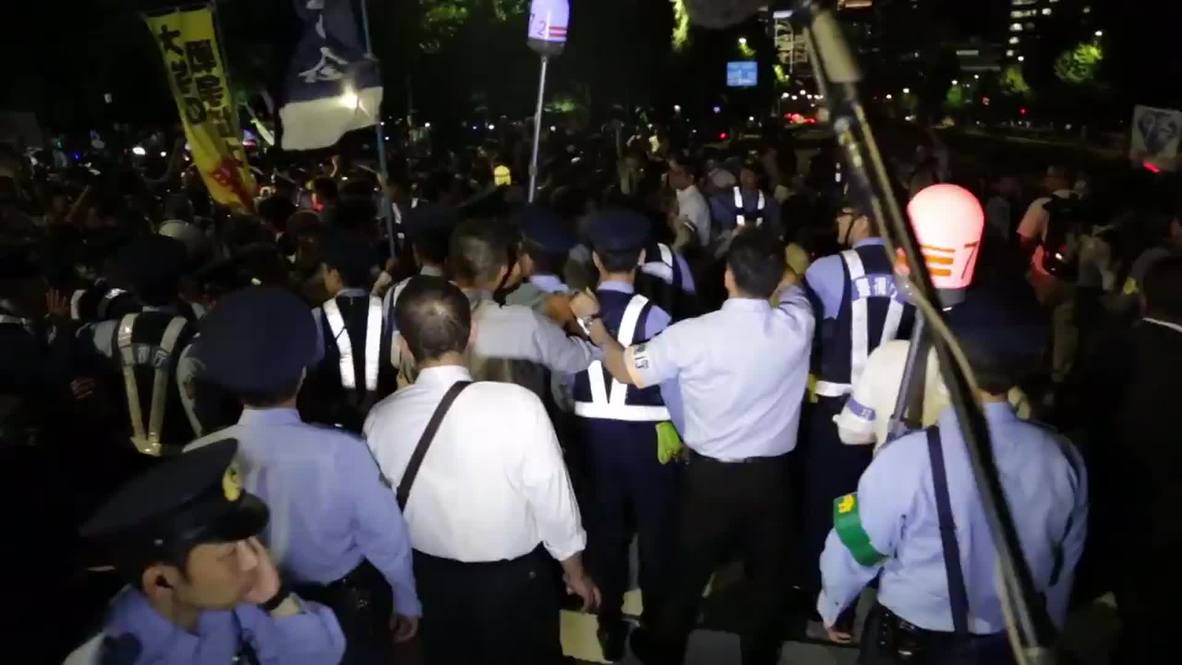 Japan: Protesters scuffle with police during anti-military protest