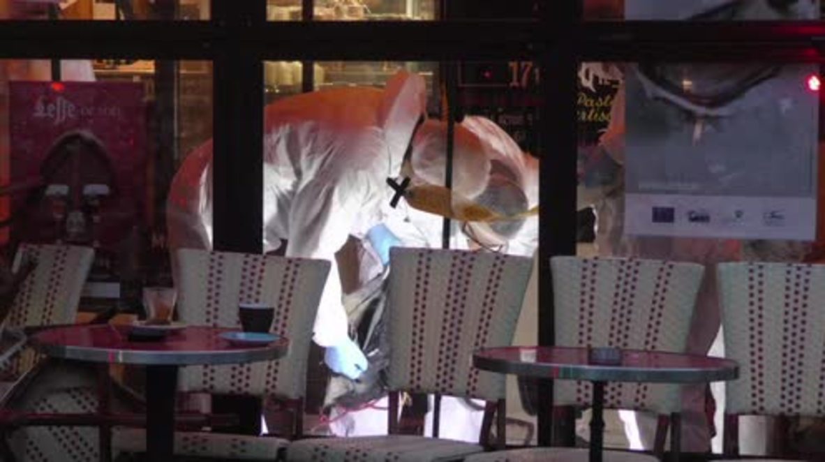France: Forensic experts inspect suicide bomber's body outside cafe 'Comptoir Voltaire'