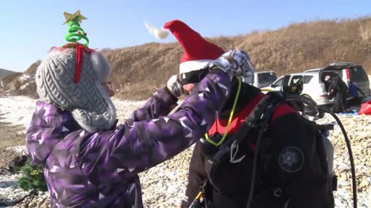Russia: Divers kick off New Year festivities by taking tree UNDERWATER