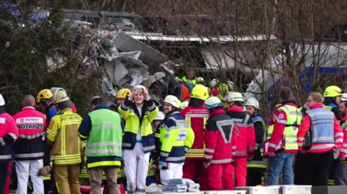 Germany: Emergency crews sift through the wreckage at deadly train crash site