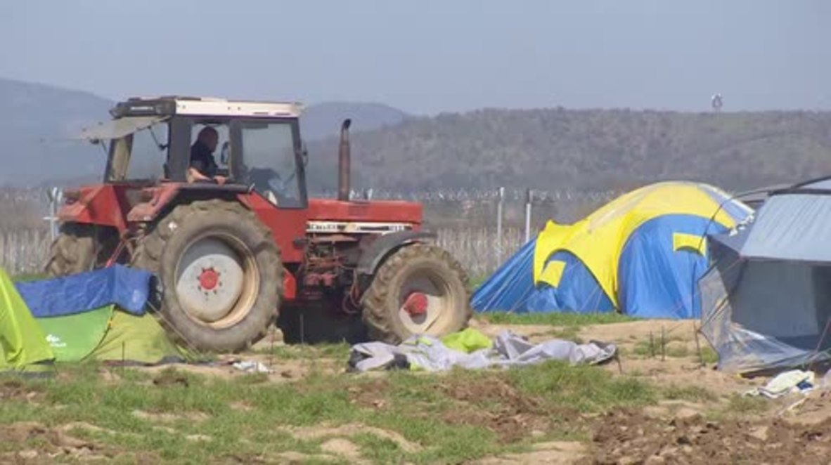 Greece: Farmer PLOUGHS land where refugees are living in tents