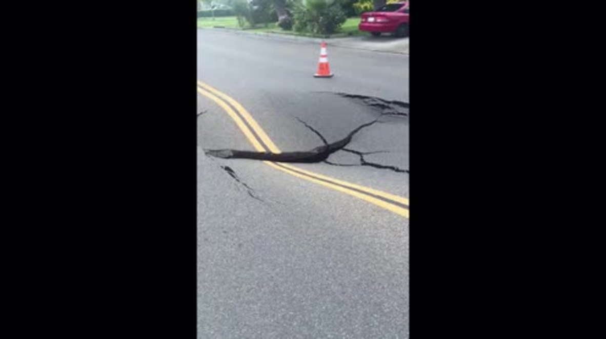 USA: See moment sinkhole swallows huge segment of road