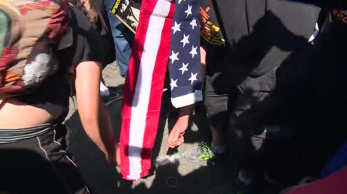 USA: Chaos ensues as 'blood-soaked' US flag BURNS outside RNC
