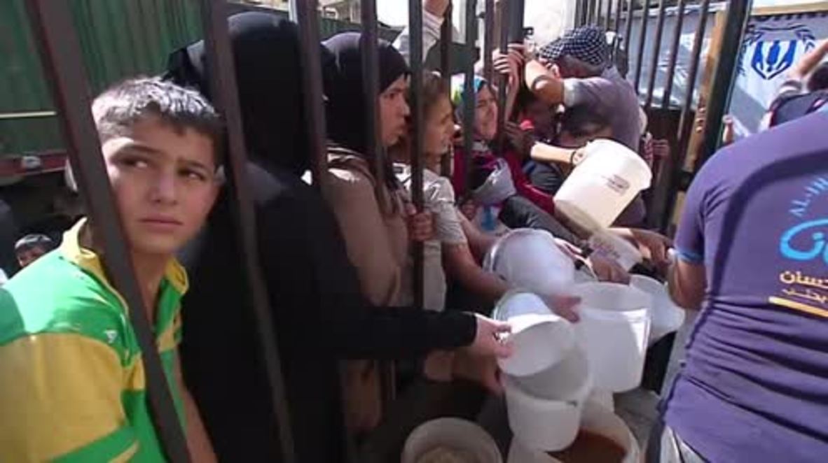 Syria: Starved Aleppo residents line up for badly needed food aid