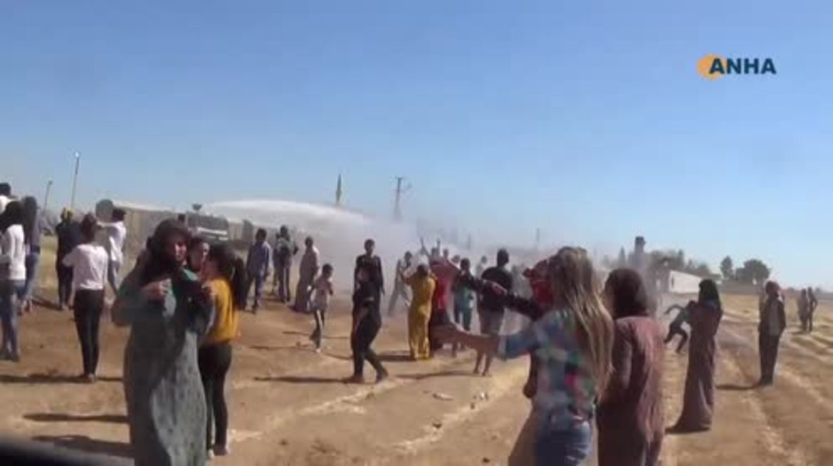 Syria: Kobane protesters flee from water cannon as Turks build border wall