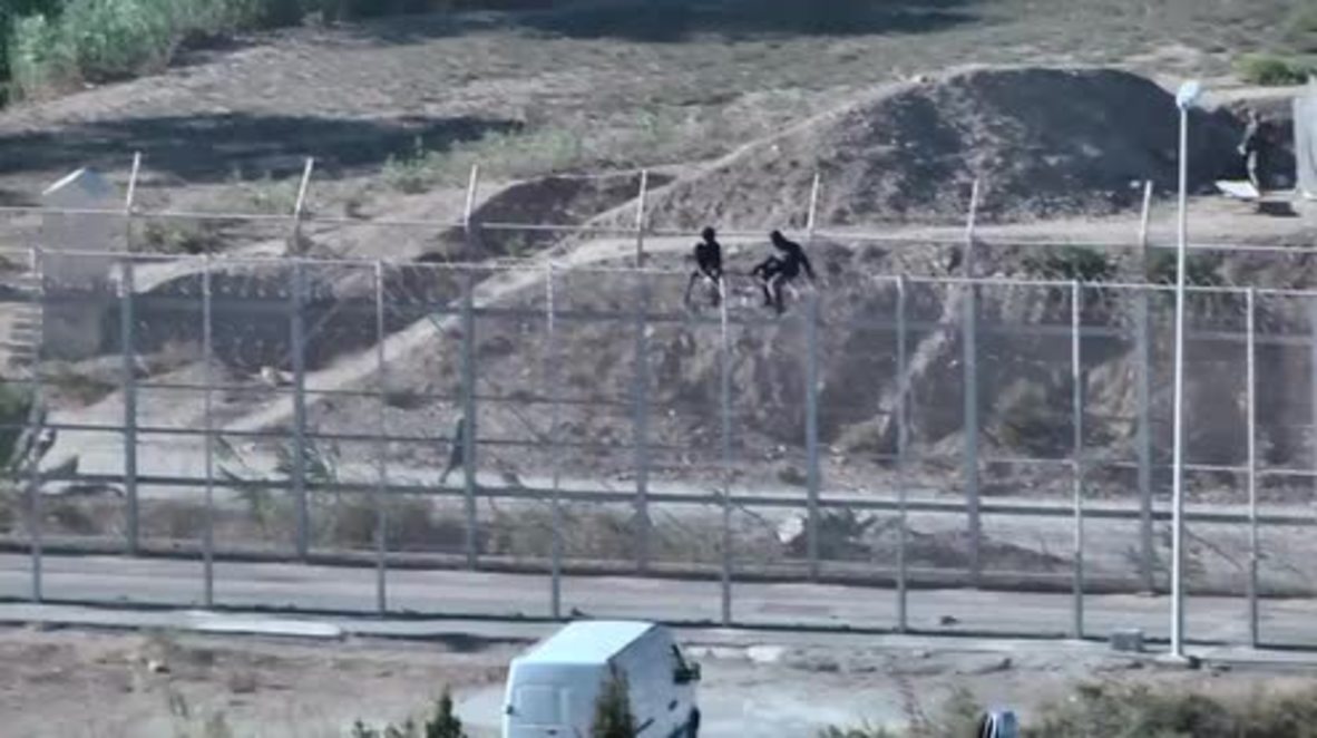 Spain: Dozens of refugees climb atop fence bordering Ceuta