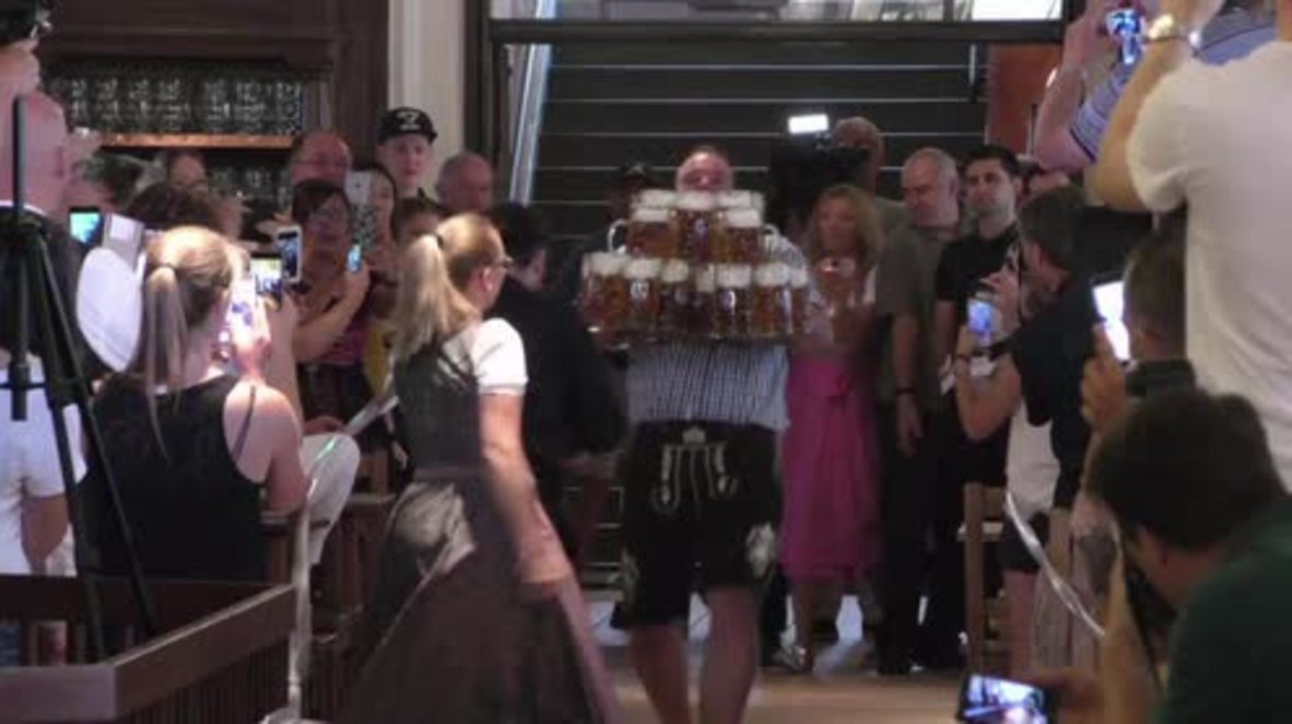 Germany: Beer juggling Bavarian lugs 27 MASSIVE mugs 40m, breaks world record