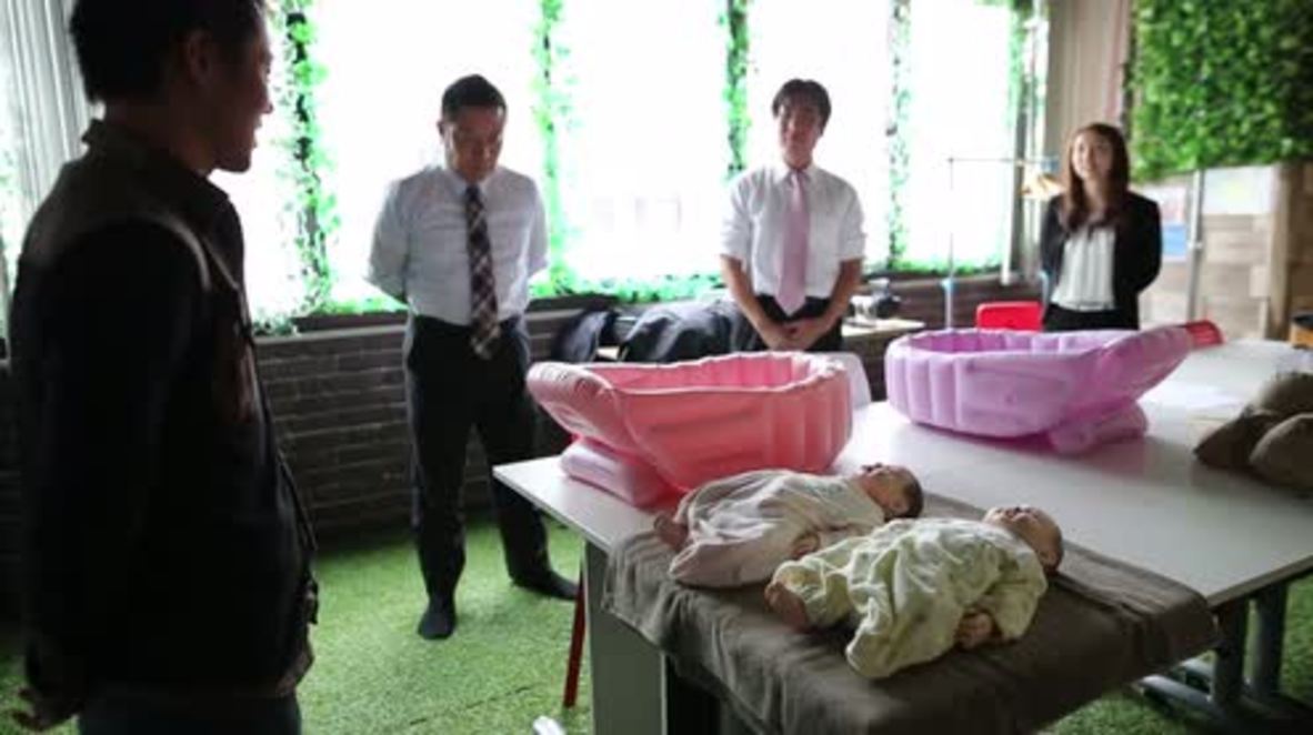 Japan: Bachelors don baby bumps and study childcare in bid to find wives