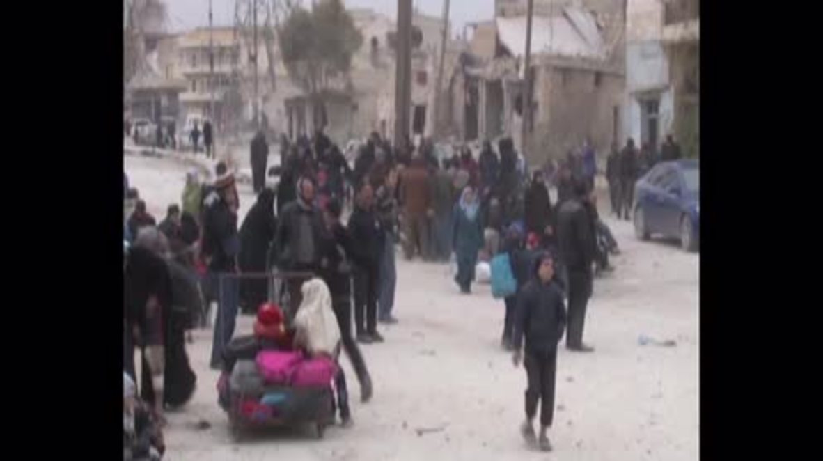 Syria: Locals walk along streets of Al Sakhour following SAA liberation of area