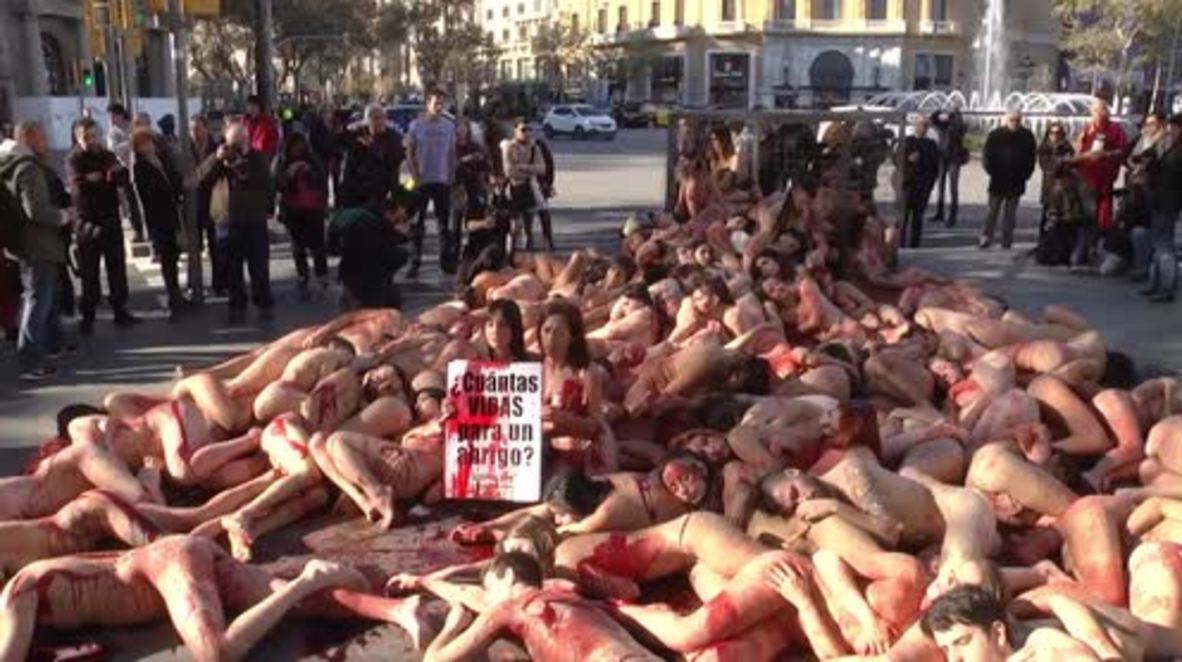 Spain: Caged, bloody, and naked, animal rights activists decry fur industry in Barcelona