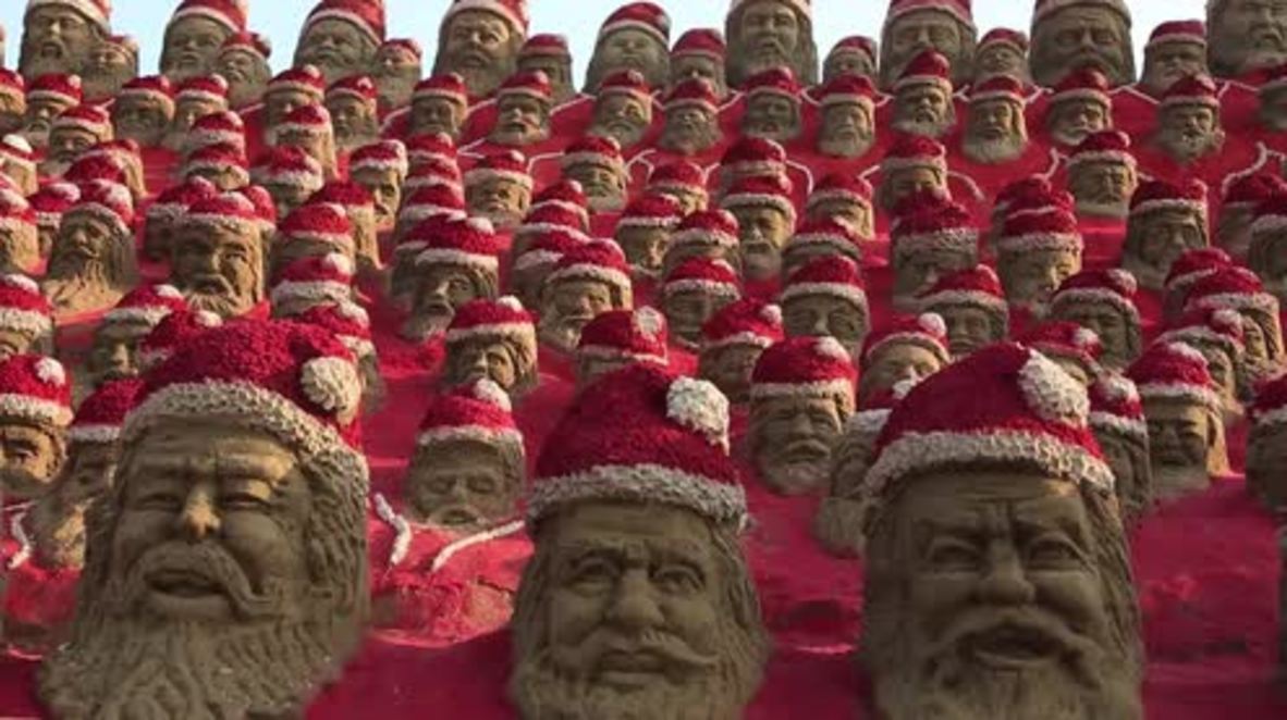 India: Artist creates 1,000 sand Santas 'to bring happiness to the world'