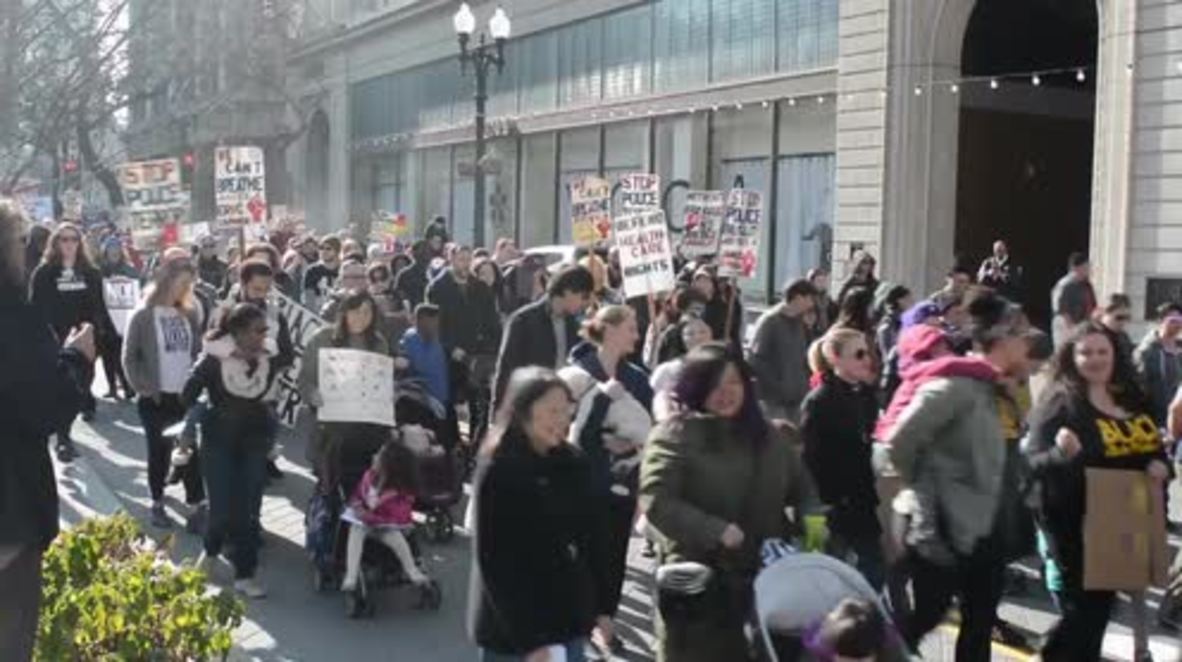 USA: Anti-police brutality protesters march through Oakland on MLK day