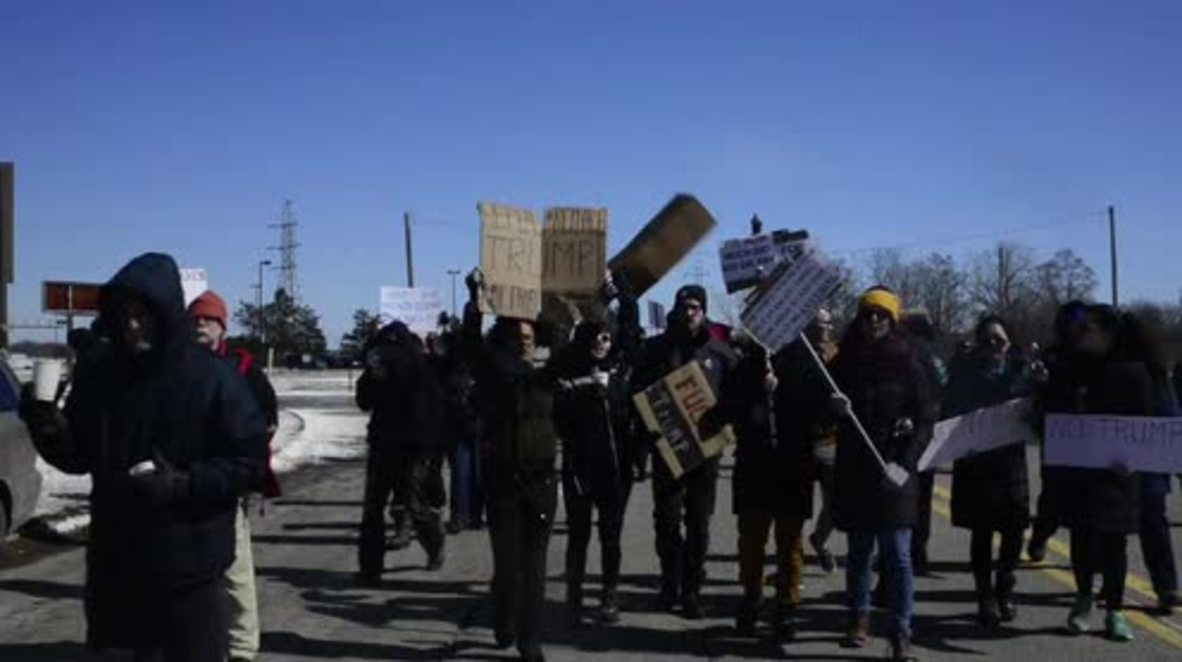 USA: Protesters denounce Trump as he arrives in Michigan for automotive industry talks