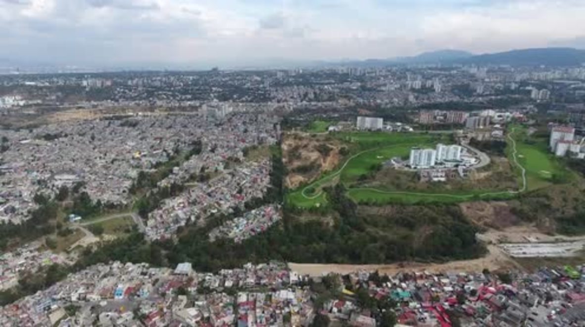 Mexico: Bird-eye view of wall dividing deprived neighbourhood from luxury golf course