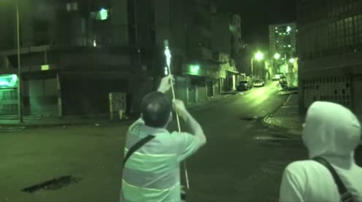 Venezuela: Protesters face off with guns and fireworks in battle for Caracas