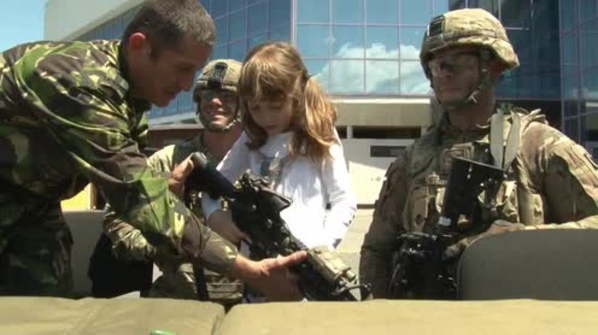 Romania: Children play with US and Romanian military equipment in Transylvania