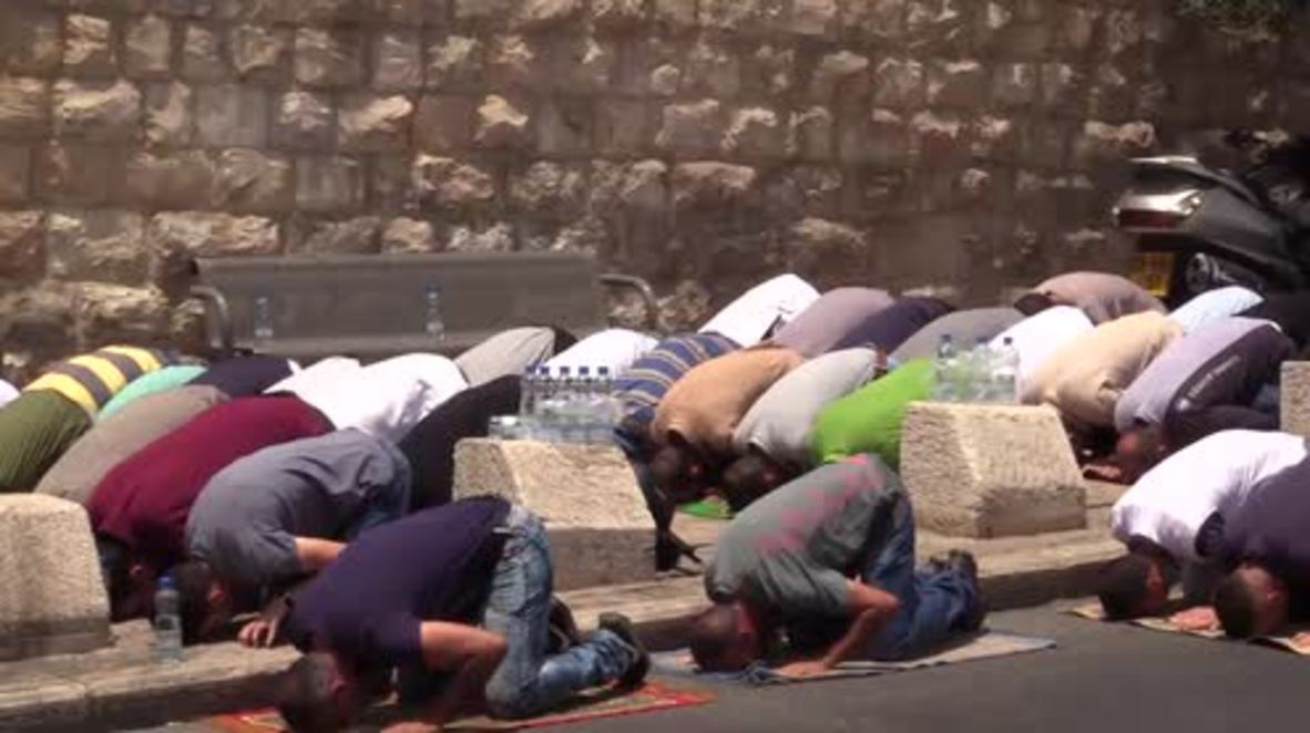 East Jerusalem: Palestinians pray outside Temple Mount amid continuing protests