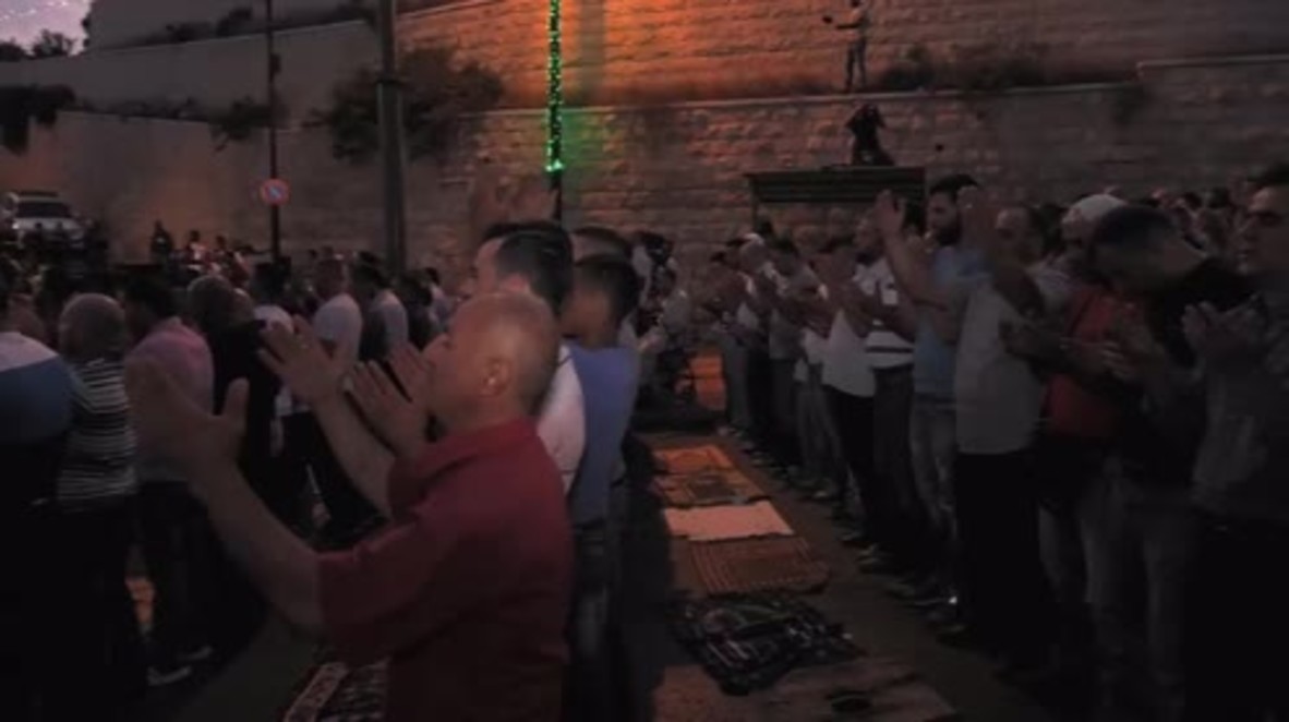 East Jerusalem: Muslim worshippers pray outdoors as tensions over al-Aqsa mosque continue