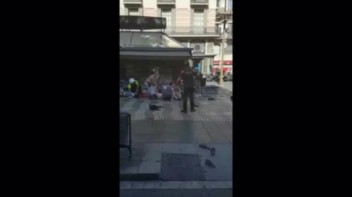 Spain: Wounded helped to their feet as bodies lay strewn across Las Ramblas *GRAPHIC*