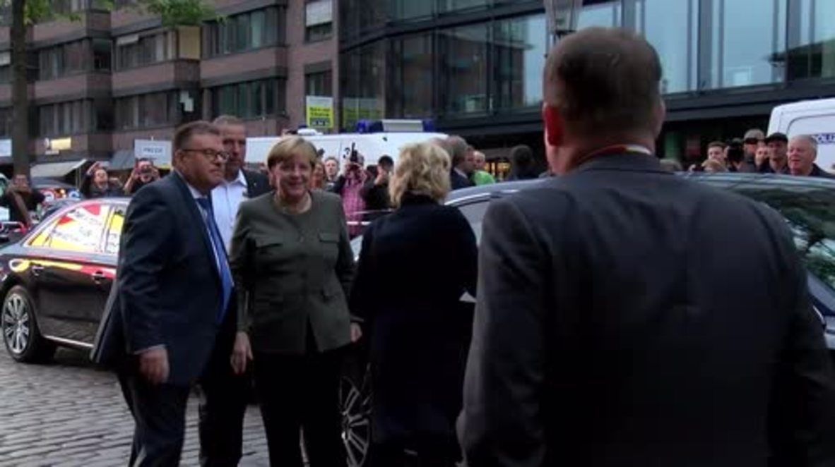 Germany: Protesters vent fury as Merkel urges international cooperation