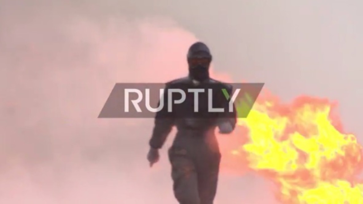 Having a blast! Stunt woman testing combat suit gives ‘hot’ whole new meaning