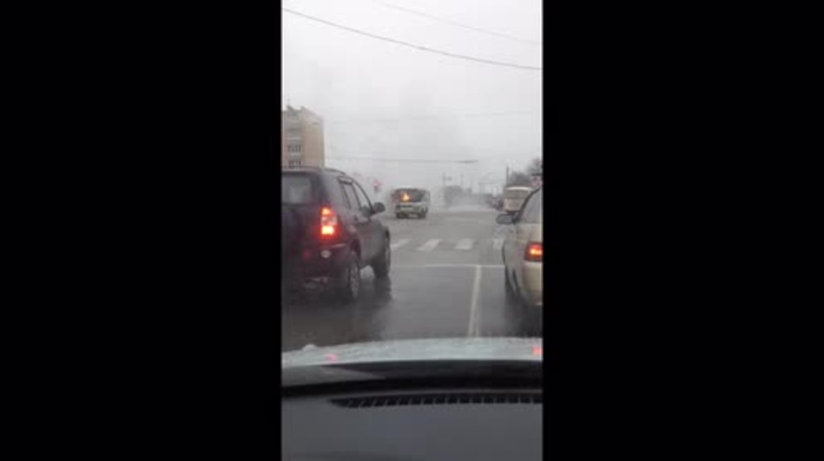 Russian man casually drives BURNING bus along highway *EXCLUSIVE*