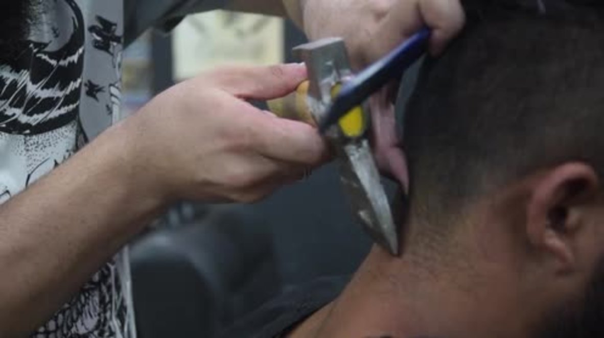 Syrian refugee gives hair the AXE in his Brasilia barbershop!