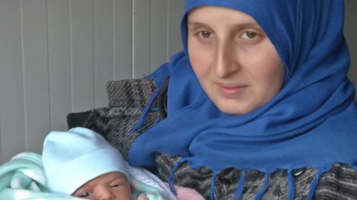 Greece: 4-day-old baby Rafif sleeping on crate among refugees braving dire conditions in Lesbos