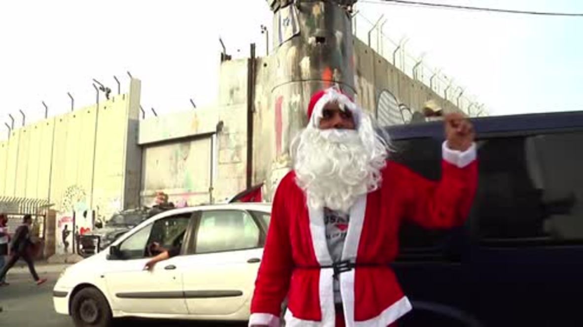 State of Palestine: Santa-costumed protesters clash with Israeli forces