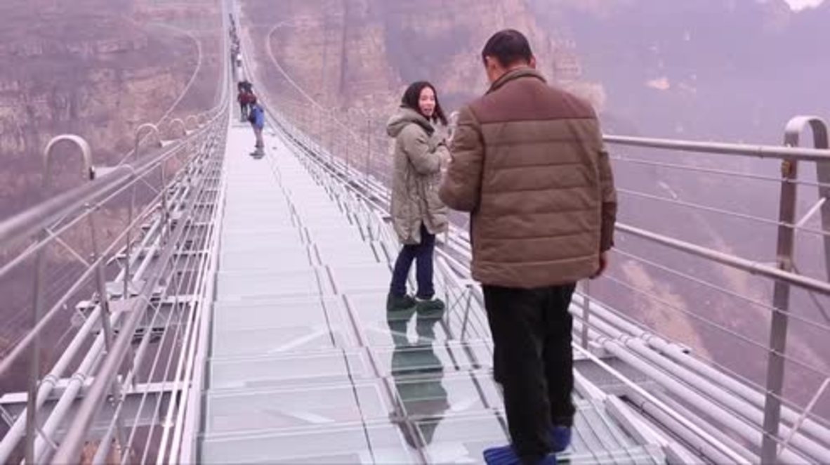 World's longest glass-bottomed bridge WOBBLES at 218 metres high