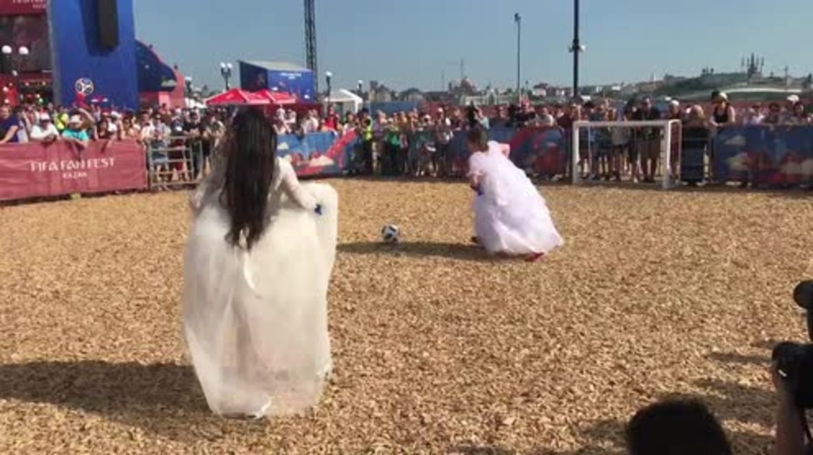 Playing away? Russian brides play footy in wedding dresses for World Cup