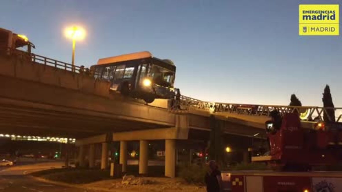 Spain: Bus crashes through barrier, hangs precariously over bridge