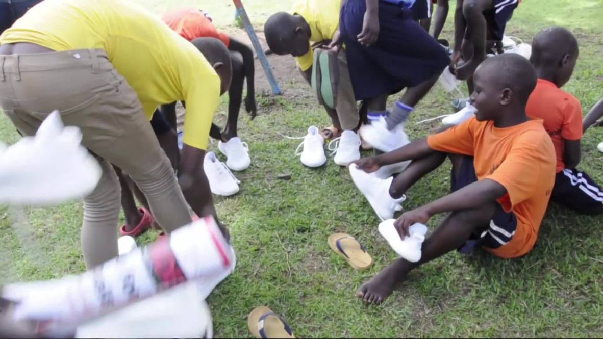 Get your kicks on! Kimye hand out free Yeezys to Ugandan schoolkids