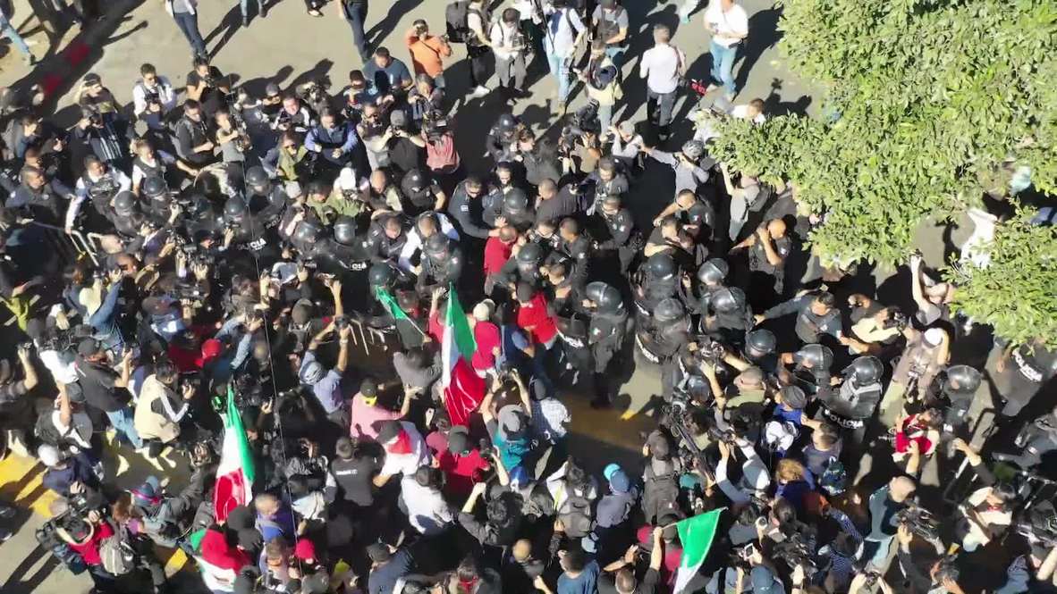 Mexico: Drone captures anti-migrant protesters clash with police in Tijuana