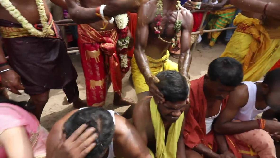Coconuts SMASHED on devotees' heads at religious festival in southern India