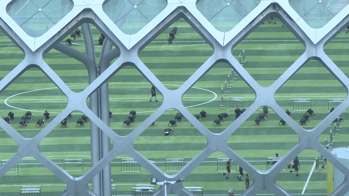 China: Football pitch becomes parade ground for Chinese soldiers