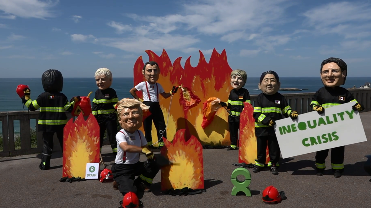 France: Protesters use masks and sand portraits to draw G7's attention to inequality