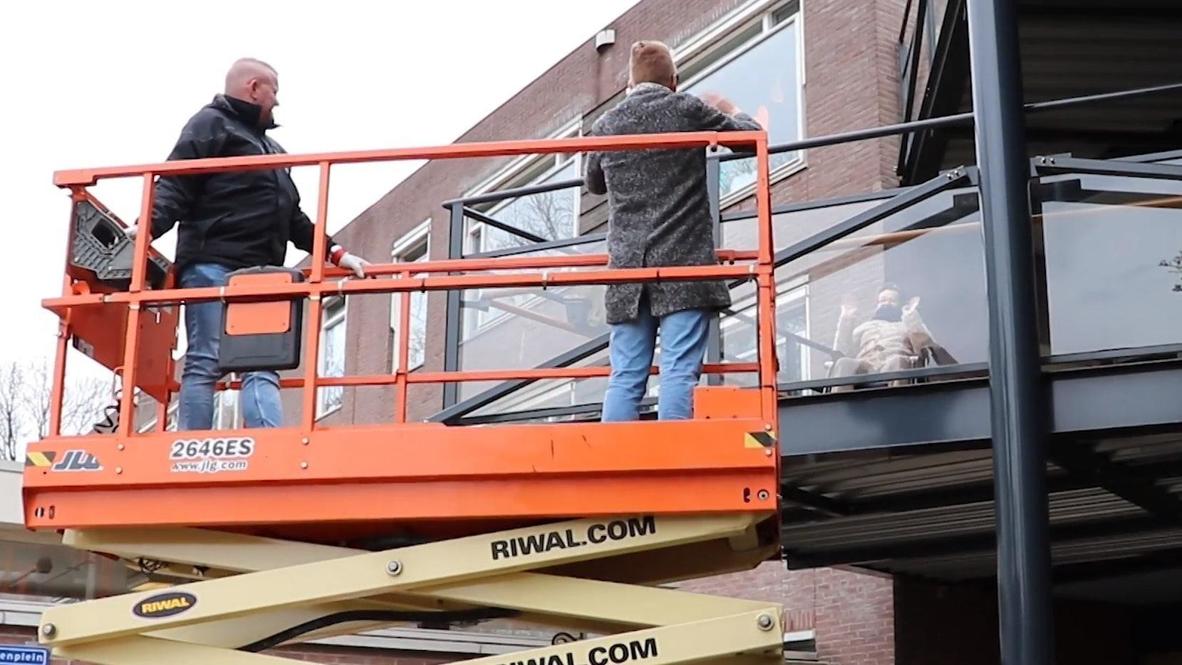 Dutch nursing home lifts up relatives with crane so they can greet loved ones amid lockdown