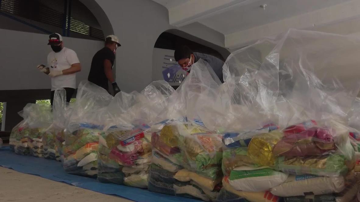Brasil: Voluntarios reparten comida a los residentes de las favelas en medio del brote de coronavirus